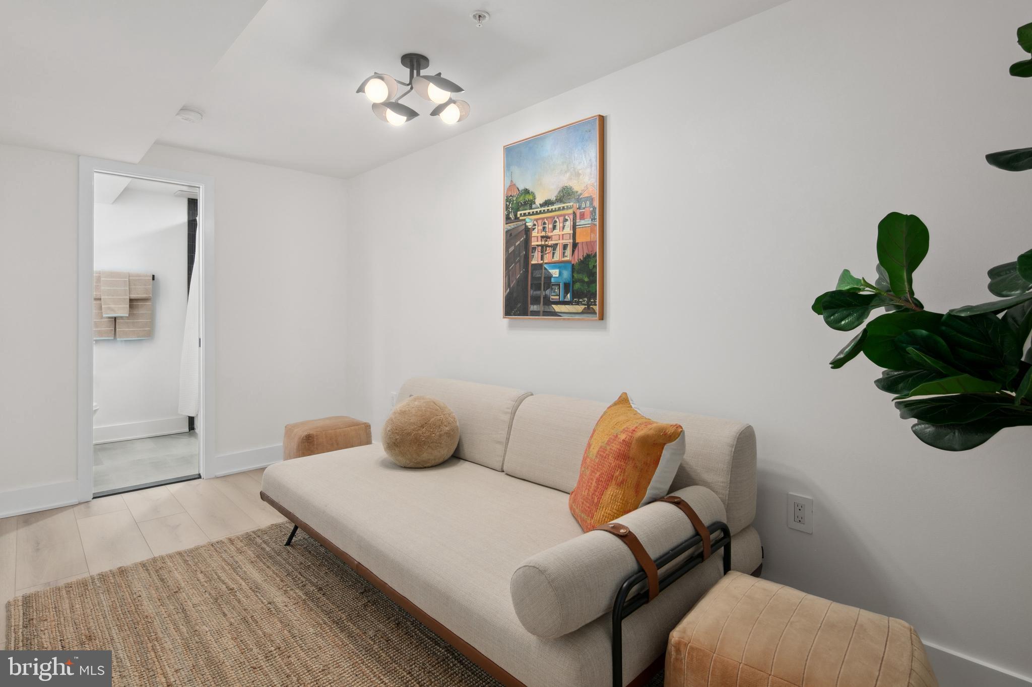 655 Morton Place Northeast, Unit 1 Washington, DC 20002 - Photo 18 of 26 a bedroom with a bed and wooden floor
