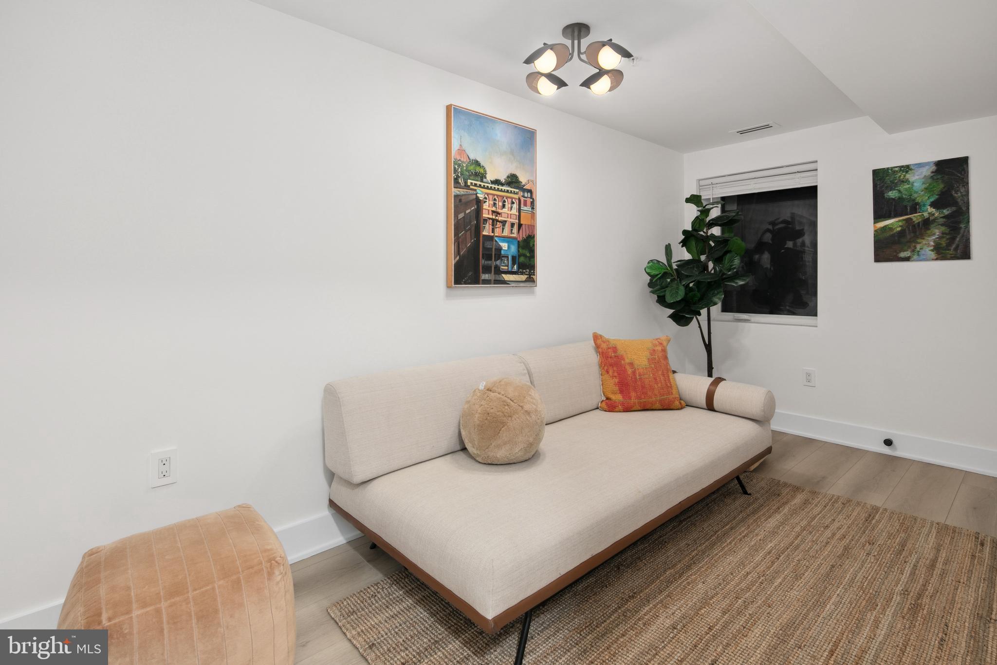 655 Morton Place Northeast, Unit 1 Washington, DC 20002 - Photo 19 of 26 a bedroom with a bed and a flat screen tv