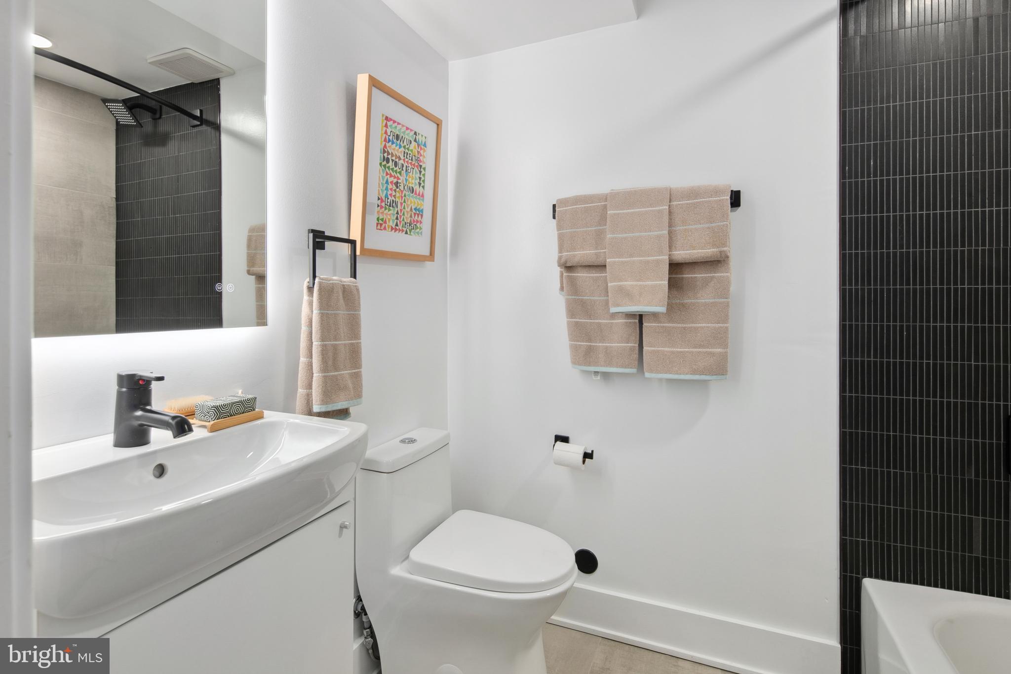 655 Morton Place Northeast, Unit 1 Washington, DC 20002 - Photo 20 of 26 a bathroom with a sink toilet and shower