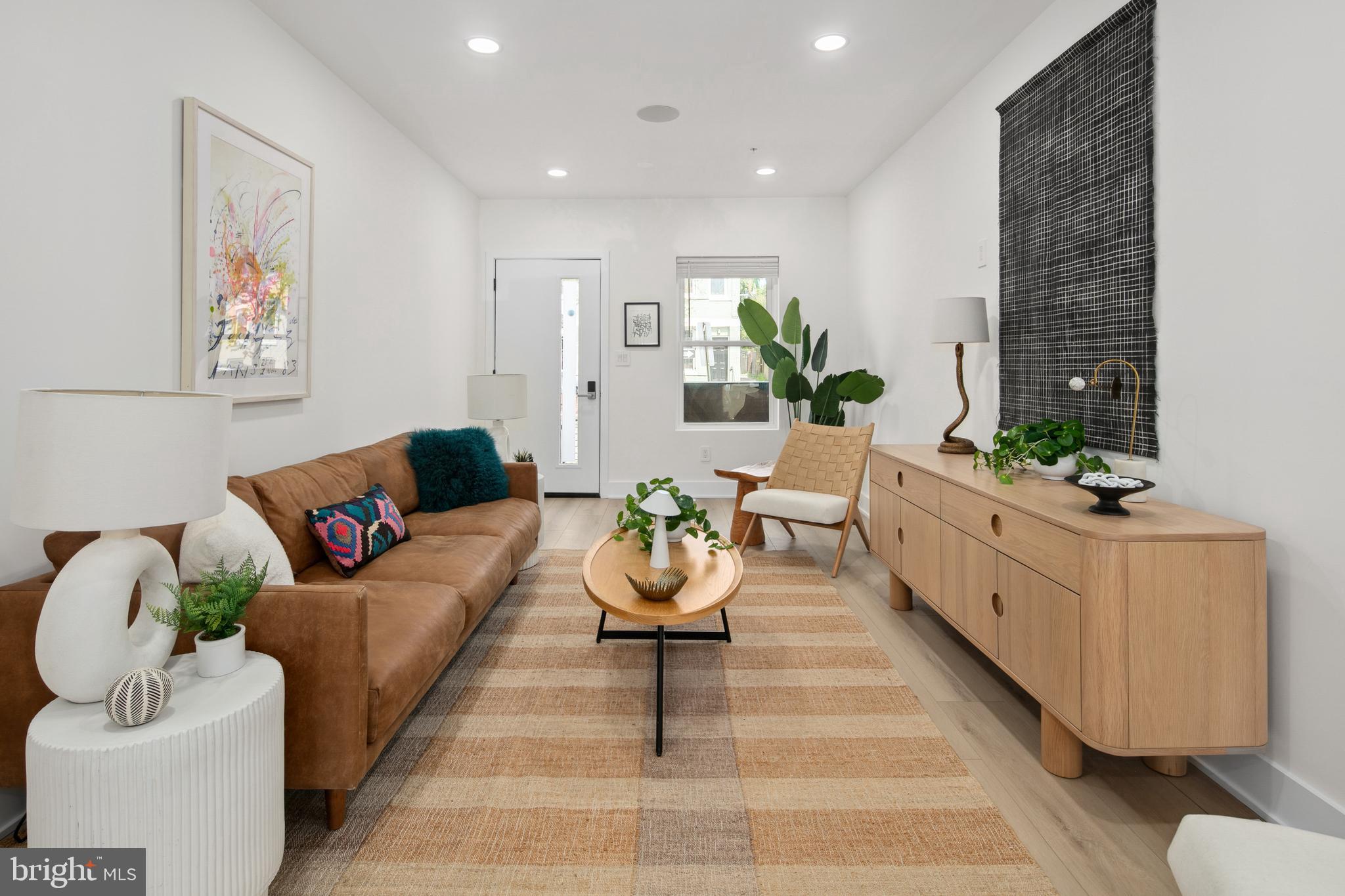 655 Morton Place Northeast, Unit 1 Washington, DC 20002 - Photo 2 of 26 a living room with furniture flowerpot and a potted plant