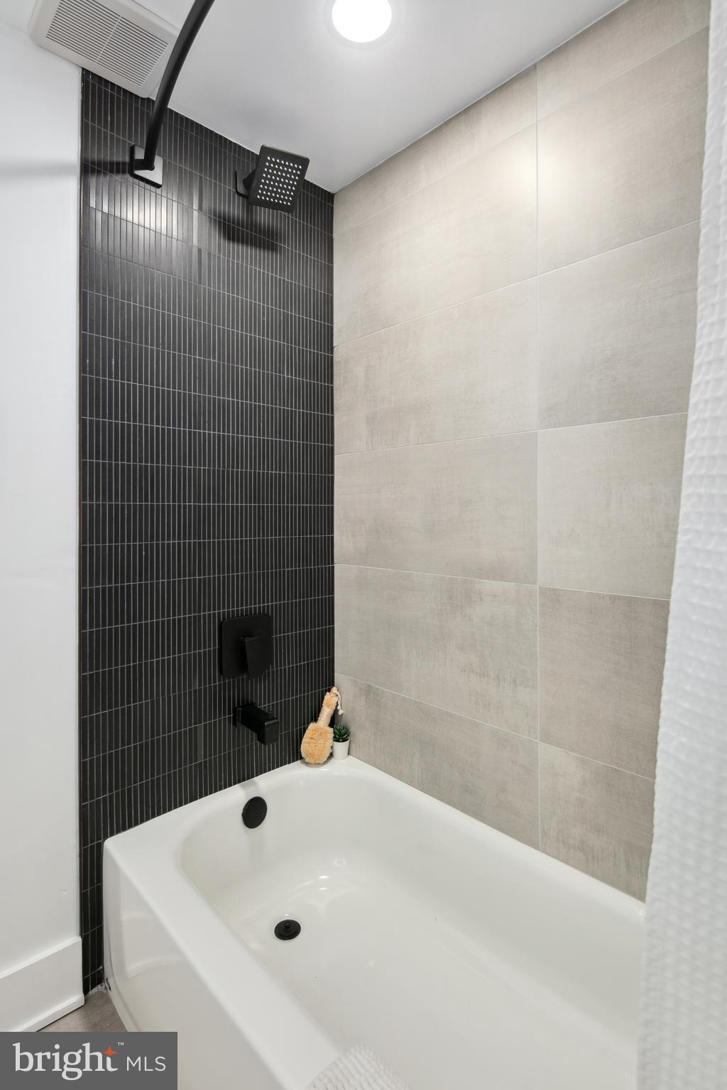 655 Morton Place Northeast, Unit 1 Washington, DC 20002 - Photo 21 of 26 a bathroom with a bathtub and shower