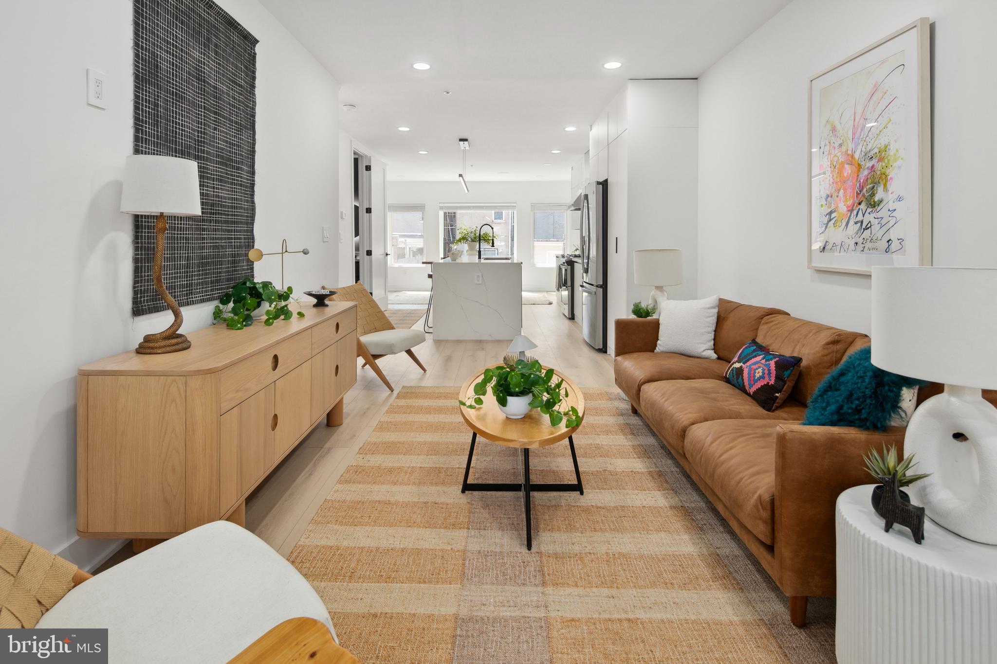 655 Morton Place Northeast, Unit 1 Washington, DC 20002 - Photo 3 of 26 a living room with furniture or couch and a kitchen