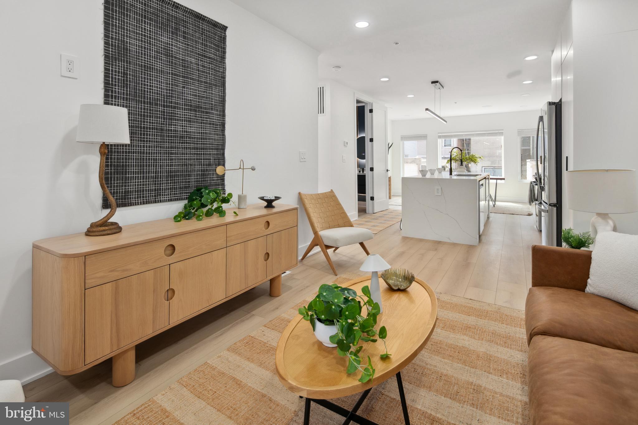 655 Morton Place Northeast, Unit 1 Washington, DC 20002 - Photo 4 of 26 a living room with furniture kitchen view and a potted plant
