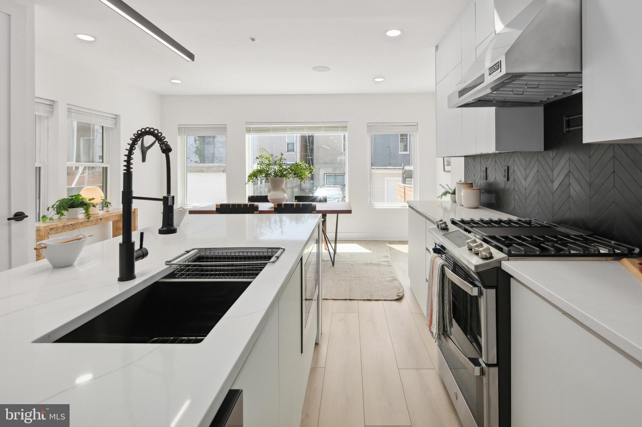 655 Morton Place Northeast, Unit 1 Washington, DC 20002 - Photo 8 of 26 a kitchen with a sink a stove and cabinets