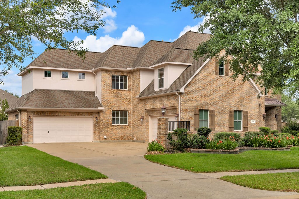 7306 Starflower Katy, TX 77494 - Photo 4 of 50 a front view of a house with a yard and garage