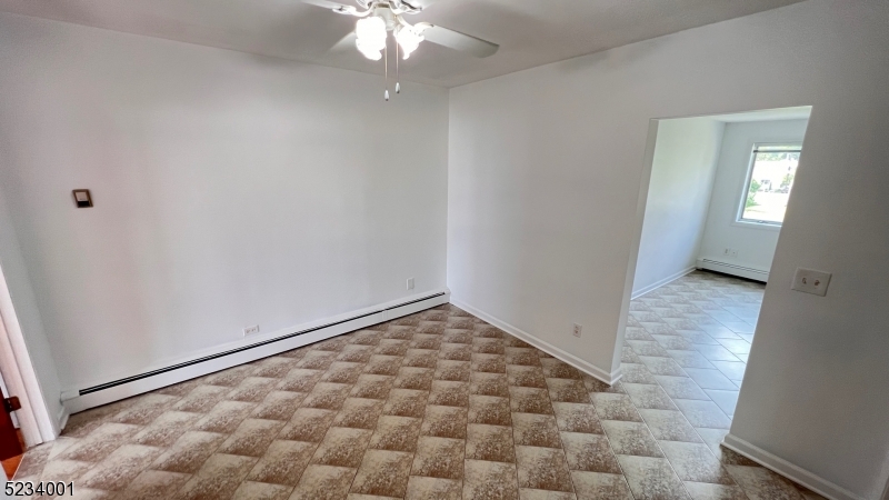 74 Mill Street Bloomfield, NJ 07003 - Photo 6 of 10 wooden floor in an empty room with a bathroom