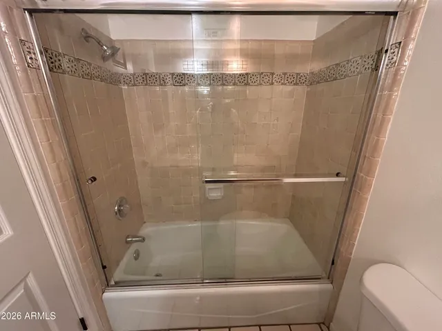 a bathroom with a shower and toilet