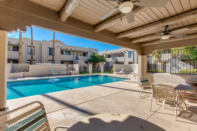 a view of a patio with a table and chairs
