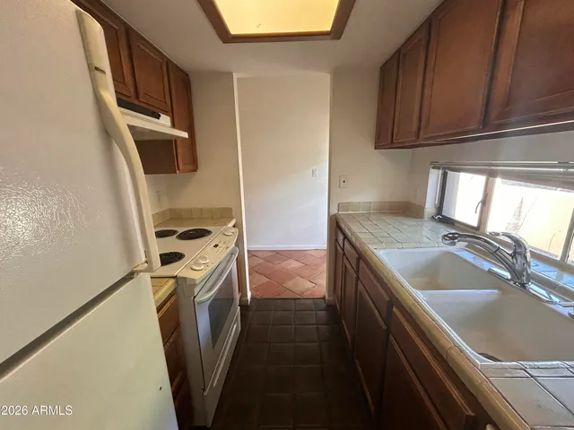 a kitchen with a sink a washer and dryer