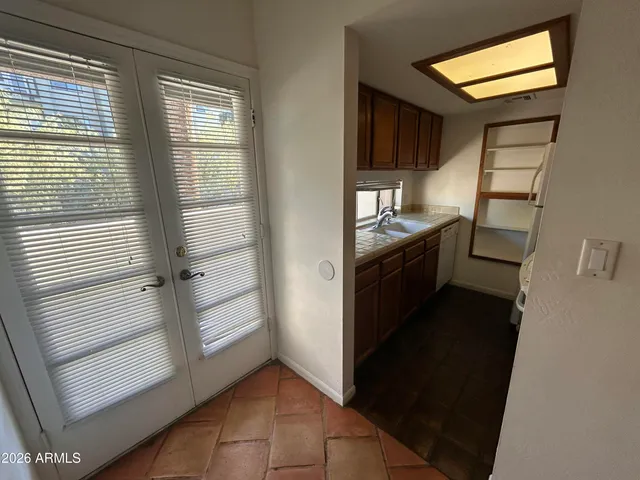a kitchen with granite countertop a refrigerator and a sink