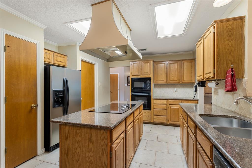 2708 Whitby Lane Grapevine, TX 76051 - Photo 13 of 32 a kitchen with stainless steel appliances granite countertop a sink a refrigerator and a stove
