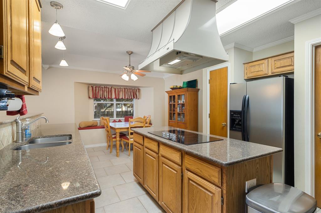 2708 Whitby Lane Grapevine, TX 76051 - Photo 14 of 32 a kitchen with stainless steel appliances granite countertop a sink a stove and a refrigerator