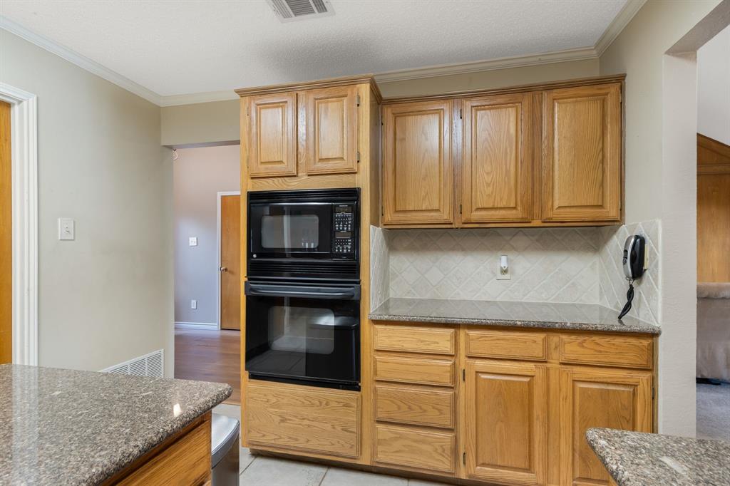 2708 Whitby Lane Grapevine, TX 76051 - Photo 15 of 32 a kitchen with granite countertop cabinets stainless steel appliances and a counter space