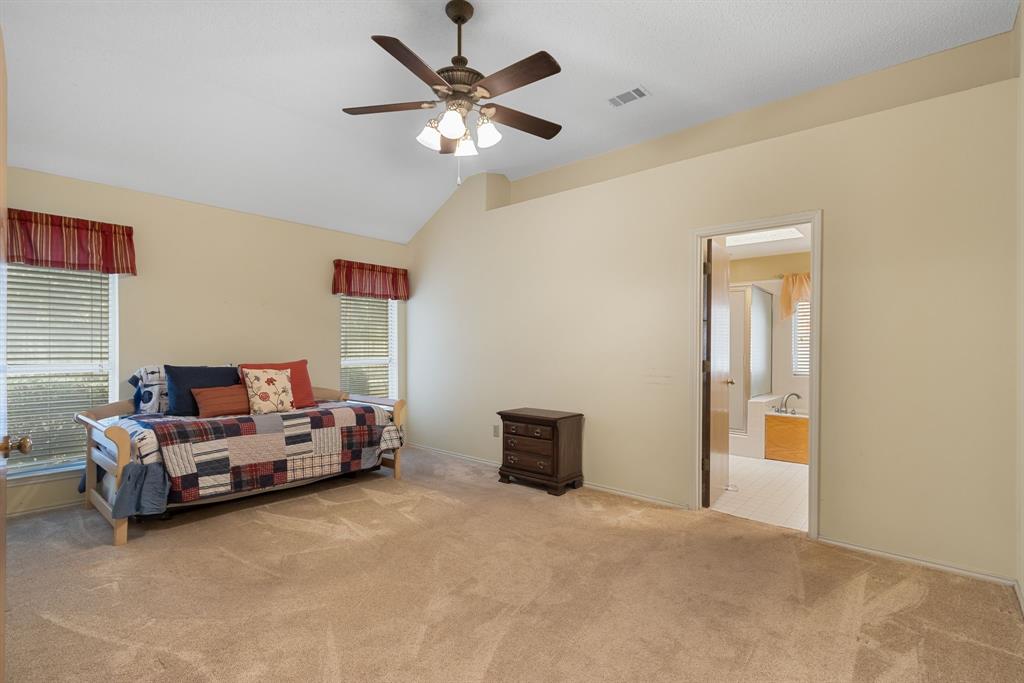 2708 Whitby Lane Grapevine, TX 76051 - Photo 16 of 32 a bed room with a bed and a chandelier