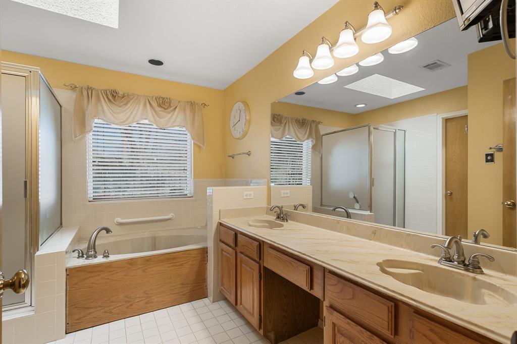 2708 Whitby Lane Grapevine, TX 76051 - Photo 18 of 32 a bathroom with a tub sink and mirror