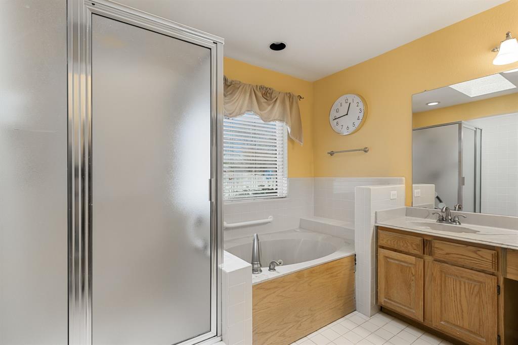 2708 Whitby Lane Grapevine, TX 76051 - Photo 19 of 32 a bathroom with a tub sink and mirror
