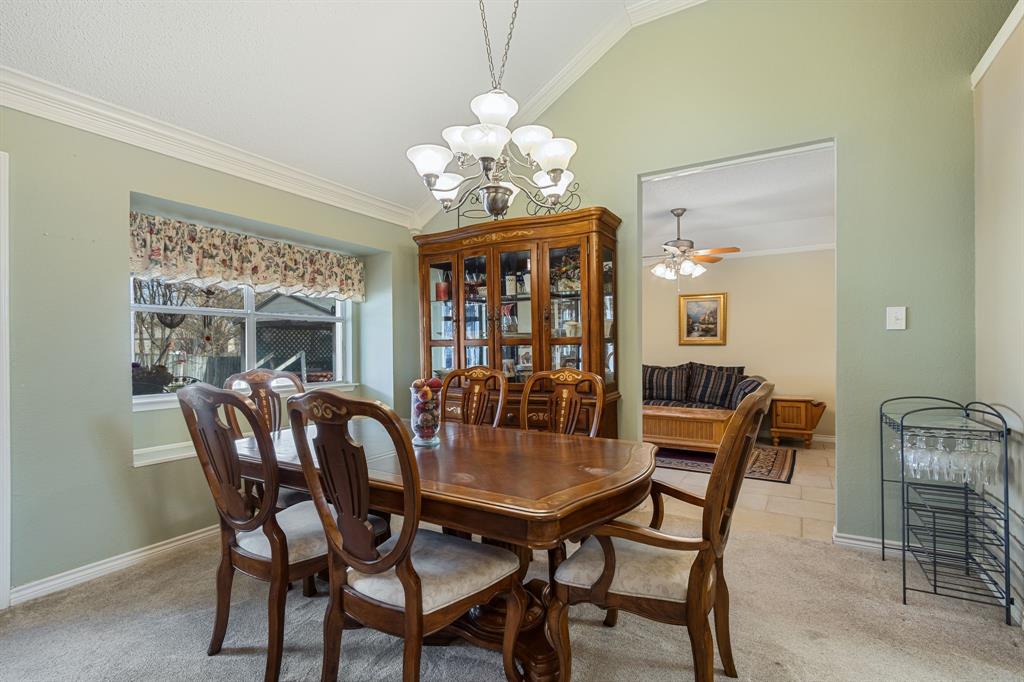 2708 Whitby Lane Grapevine, TX 76051 - Photo 8 of 32 a dining room with furniture a chandelier and window