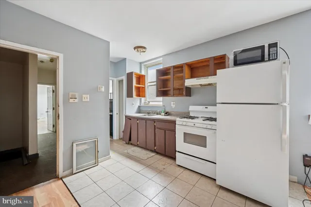 a kitchen with stainless steel appliances granite countertop a refrigerator sink and stove