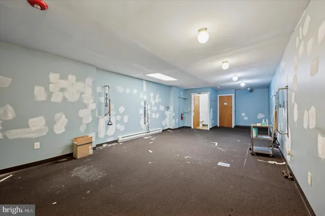 a view of a room with gym equipment and a window