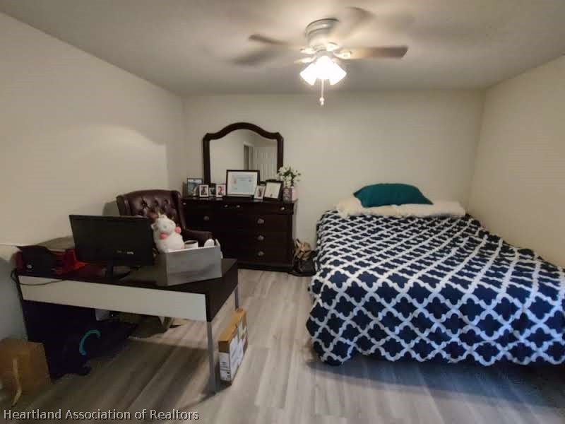 4010 Leaf Road Sebring, FL 33875 - Photo 24 of 35 a bedroom with a bed and a chandelier