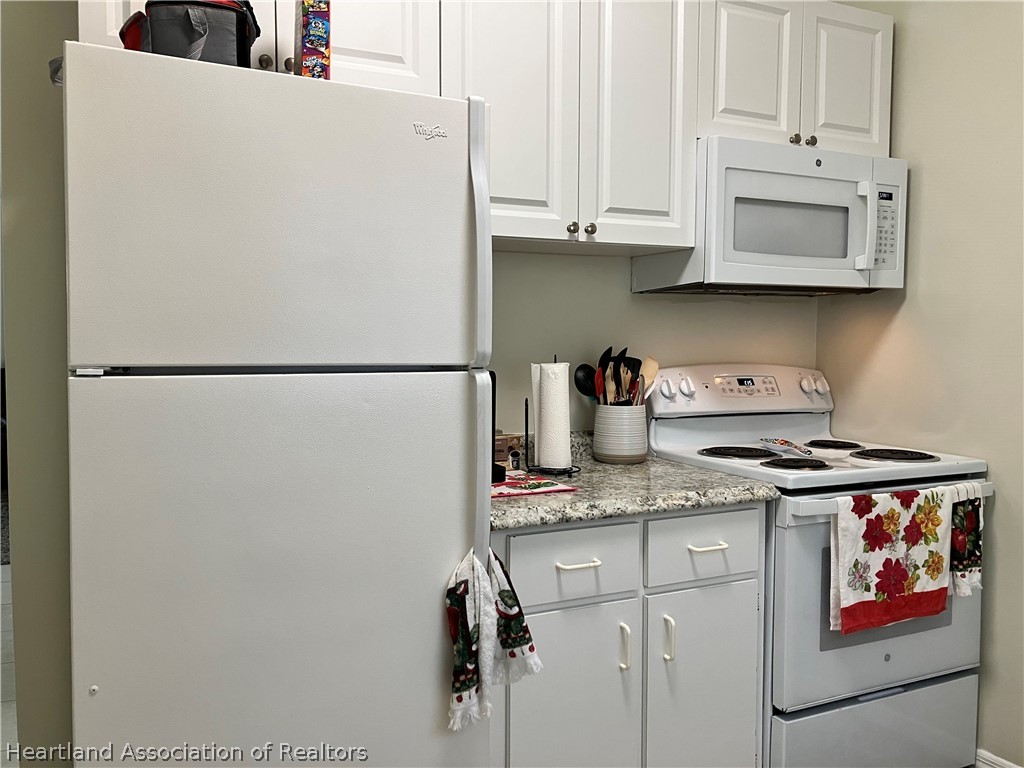 4010 Leaf Road Sebring, FL 33875 - Photo 3 of 35 a white refrigerator freezer sitting inside of a kitchen