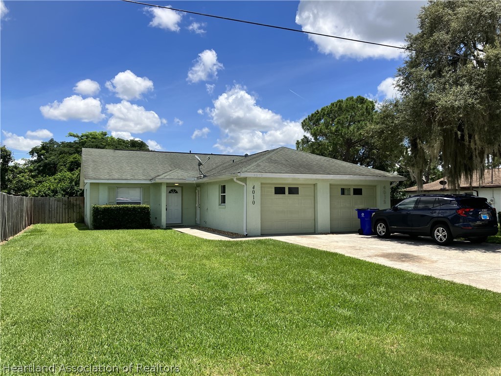 4010 Leaf Road Sebring, FL 33875 - Photo 35 of 35 a front view of a house with a yard and a garage