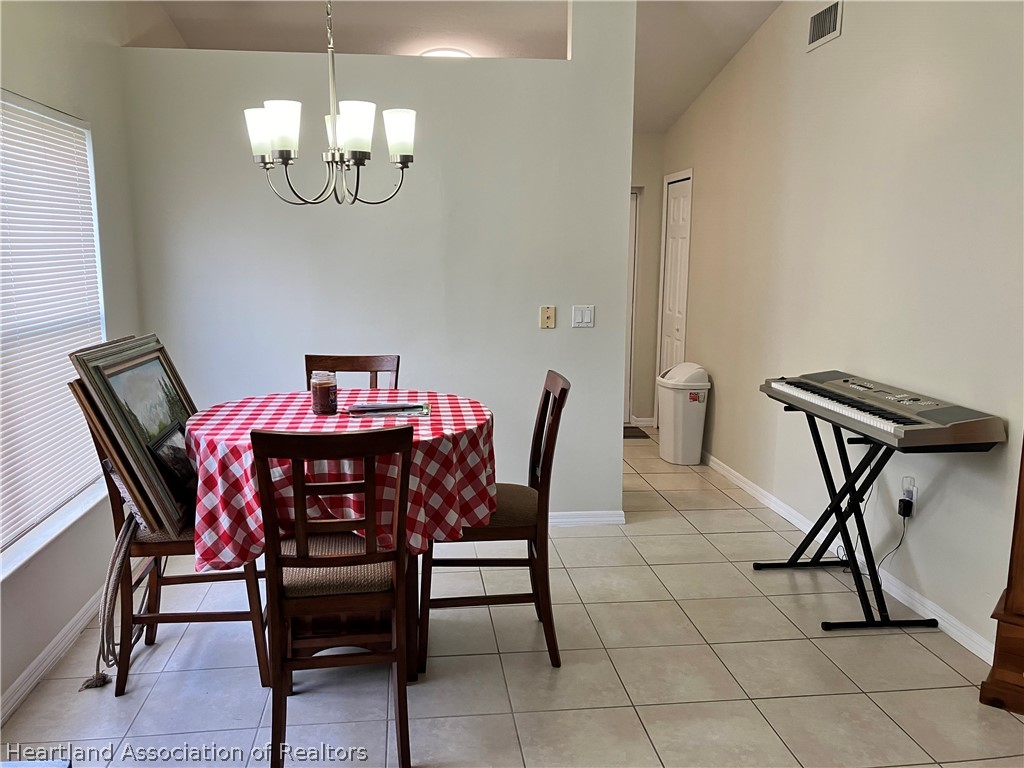 4010 Leaf Road Sebring, FL 33875 - Photo 5 of 35 a view of a dining room with furniture and chandelier