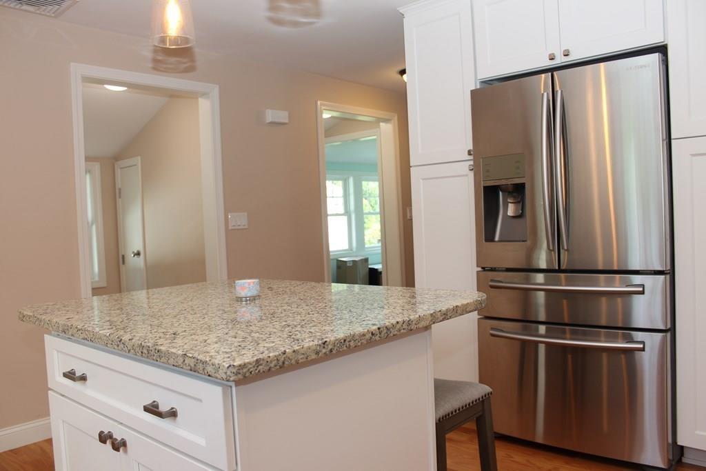 33 Riverside Drive North Reading, MA 01864 - Photo 11 of 37 a kitchen with stainless steel appliances granite countertop a refrigerator a sink and a stove