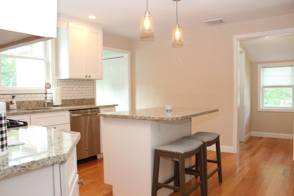 33 Riverside Drive North Reading, MA 01864 - Photo 12 of 37 a kitchen with a table chairs sink and cabinets