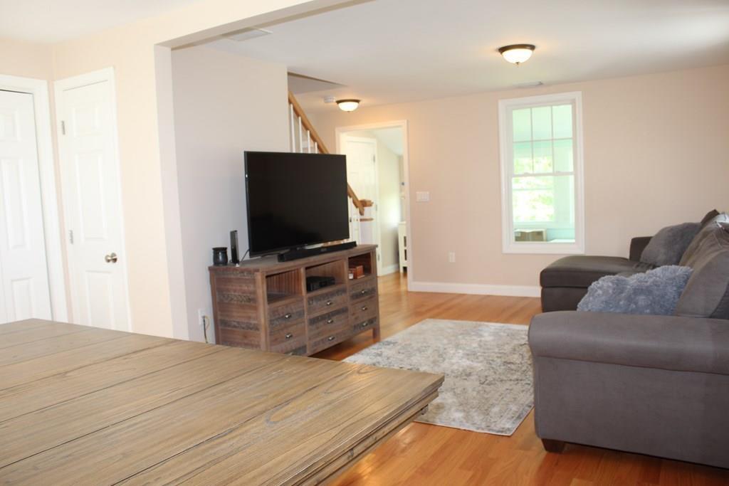 33 Riverside Drive North Reading, MA 01864 - Photo 17 of 37 a bedroom with furniture and a flat screen tv