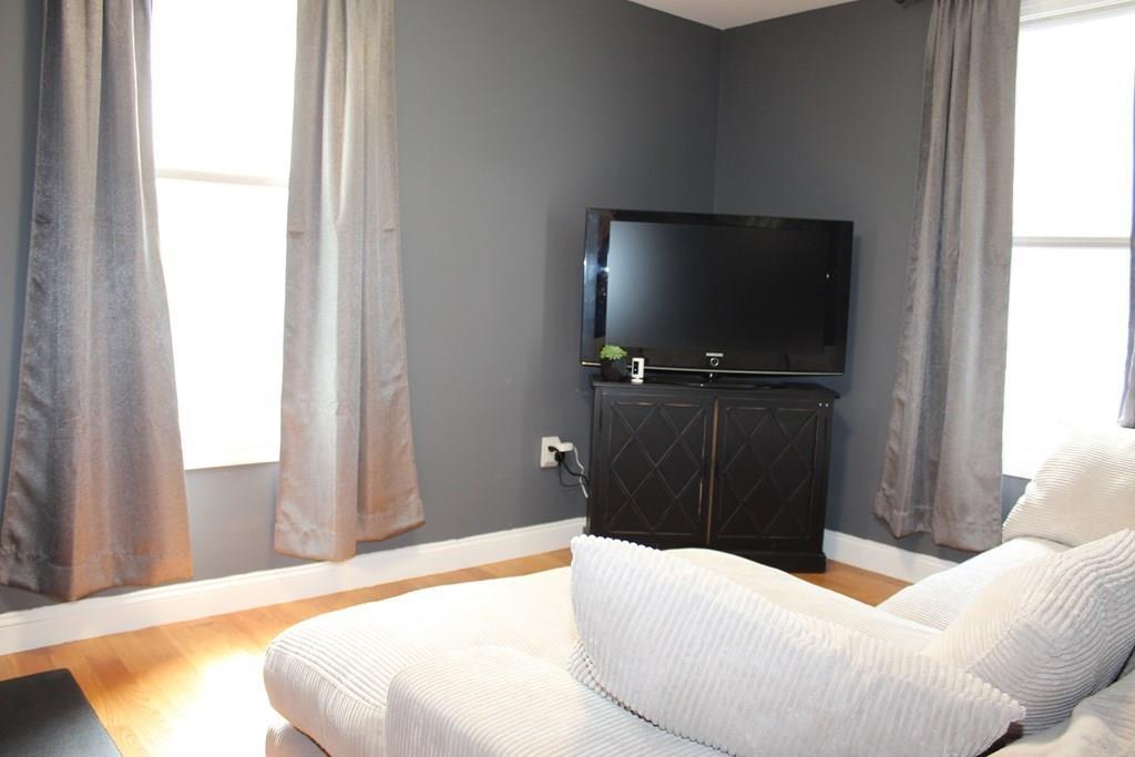 33 Riverside Drive North Reading, MA 01864 - Photo 18 of 37 a bedroom with a bed and a flat screen tv
