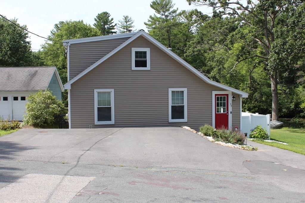 33 Riverside Drive North Reading, MA 01864 - Photo 2 of 37 a front view of house with yard and trees in the background