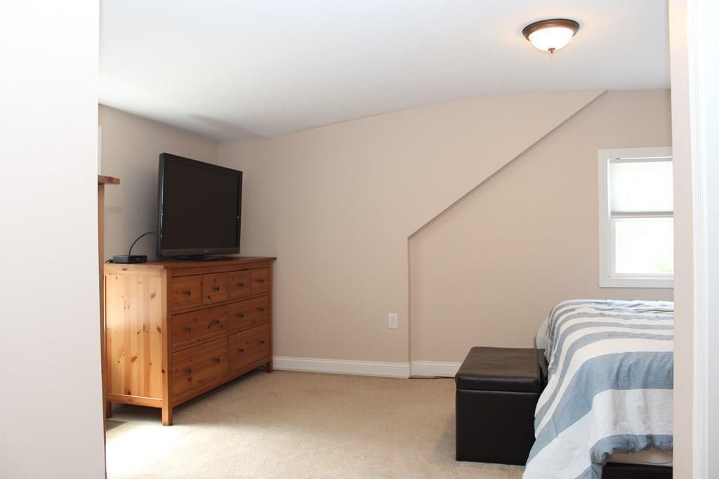 33 Riverside Drive North Reading, MA 01864 - Photo 21 of 37 a living room with furniture and a flat screen tv