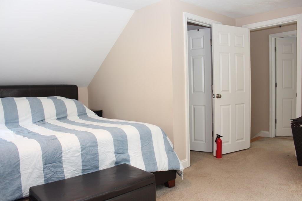 33 Riverside Drive North Reading, MA 01864 - Photo 22 of 37 a bedroom with a bed and a window