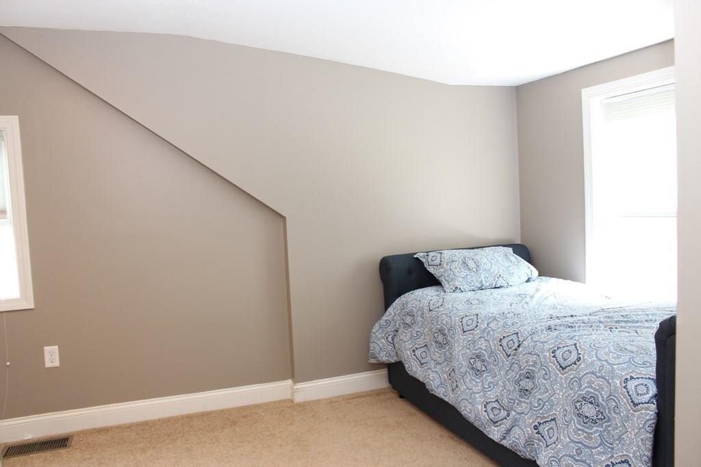 33 Riverside Drive North Reading, MA 01864 - Photo 24 of 37 a bedroom with a bed and a window