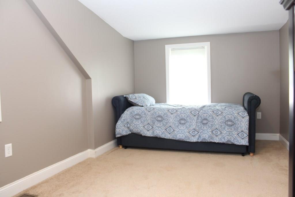 33 Riverside Drive North Reading, MA 01864 - Photo 25 of 37 a bedroom with a bed and a window