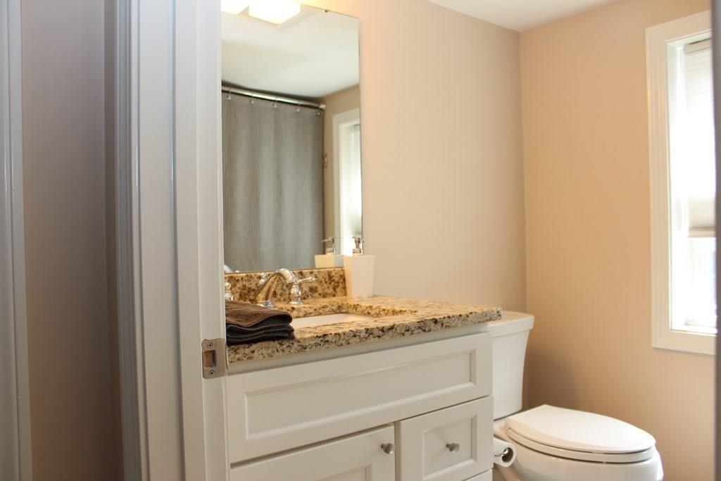33 Riverside Drive North Reading, MA 01864 - Photo 27 of 37 a bathroom with a granite countertop sink toilet and mirror