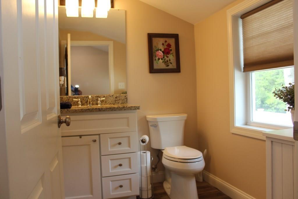 33 Riverside Drive North Reading, MA 01864 - Photo 28 of 37 a bathroom with a toilet a sink a vanity and mirror