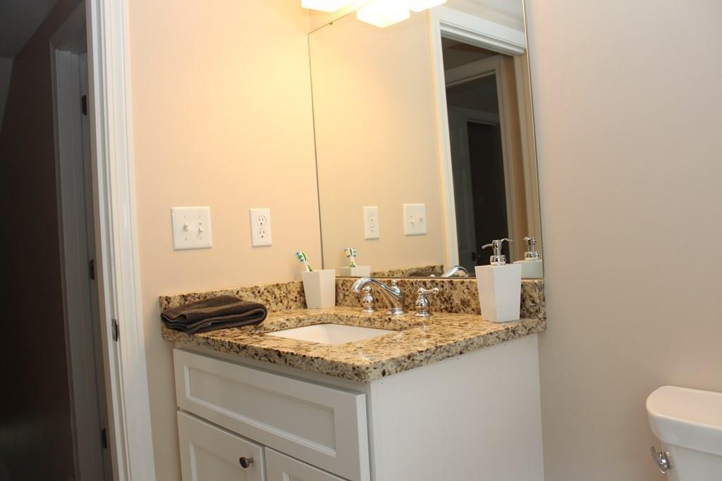33 Riverside Drive North Reading, MA 01864 - Photo 29 of 37 a kitchen with granite countertop a sink and a white stove