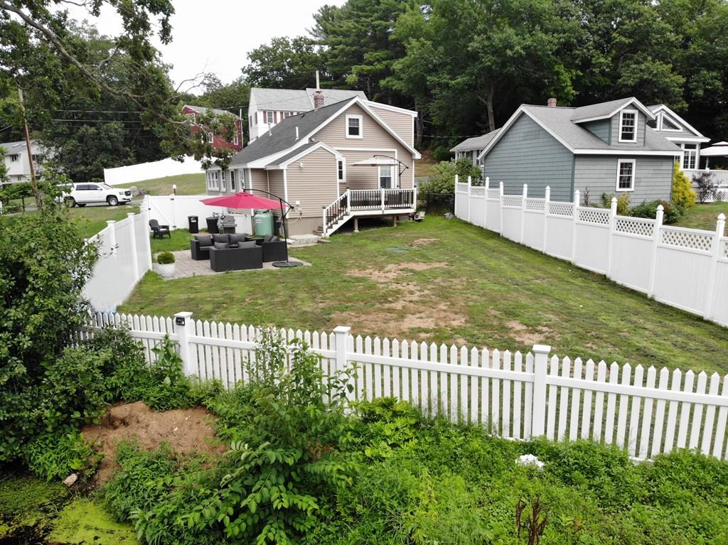 33 Riverside Drive North Reading, MA 01864 - Photo 35 of 37 a front view of a house with a yard table and chairs