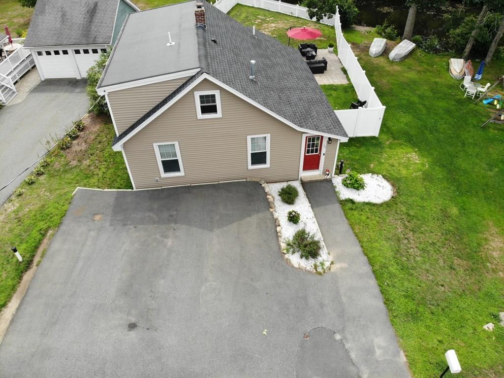 33 Riverside Drive North Reading, MA 01864 - Photo 5 of 37 a front view of a house with a yard and garage