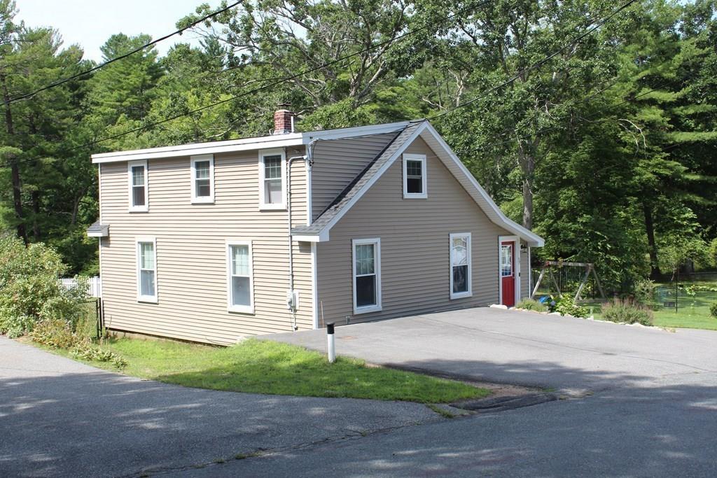 33 Riverside Drive North Reading, MA 01864 - Photo 6 of 37 a front view of a house with a yard and garage