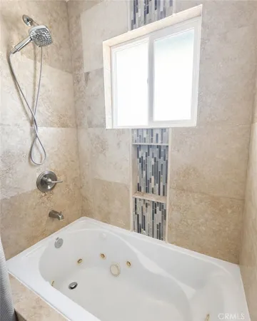 a bathroom with a bathtub and a shower