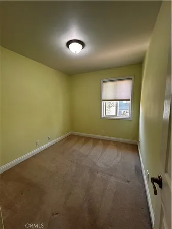 an empty room with a empty space and windows