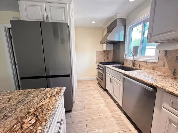 a kitchen with kitchen island a counter top space and cabinets