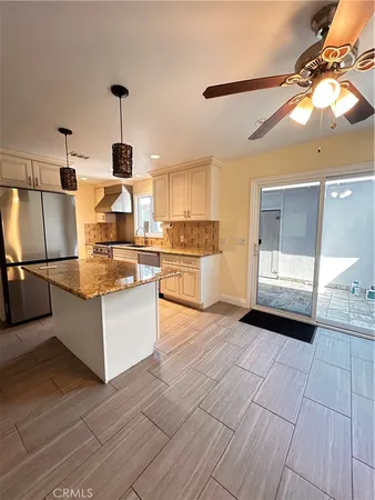 a large kitchen with cabinets and wooden floor