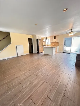 a view of a kitchen with kitchen island white cabinets and wooden floor