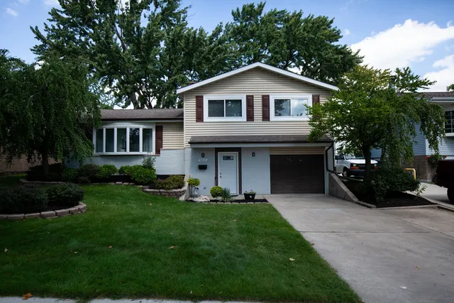 a front view of a house with a yard and porch