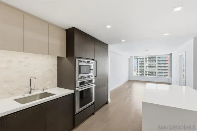 a kitchen with stainless steel appliances a sink and a refrigerator