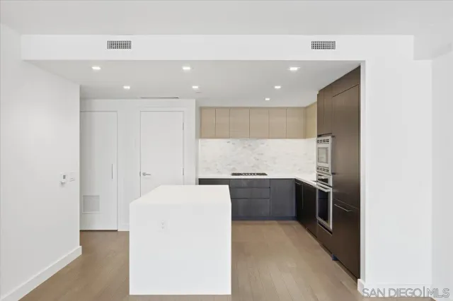 a kitchen with stainless steel appliances granite countertop a refrigerator and a stove